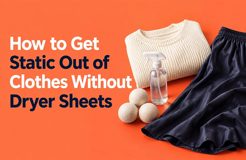 Cream knitted jumper, navy satin skirt, wool dryer balls and a water spray bottle on an orange background